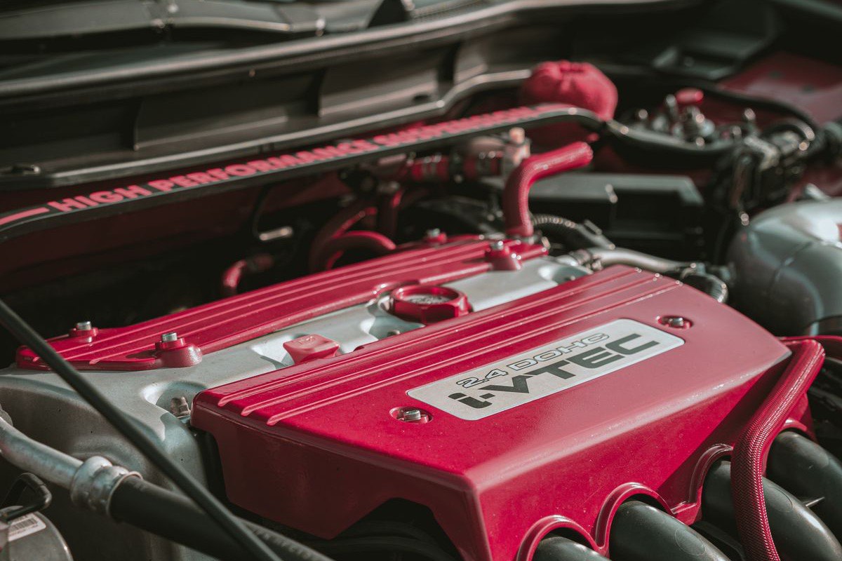 Close view of an engine bay showing a cylinder head cover